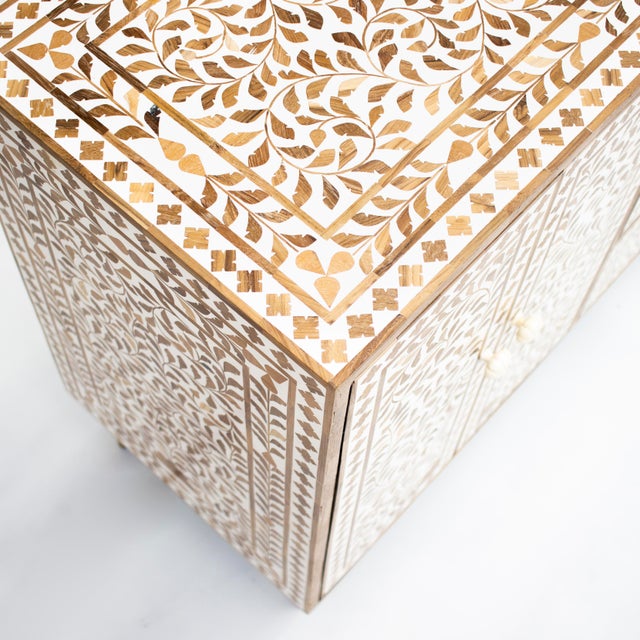 The Arabesque Teak Wood Inlay Four-Door Buffet explores traditional botanical ornamentation through an intricate...