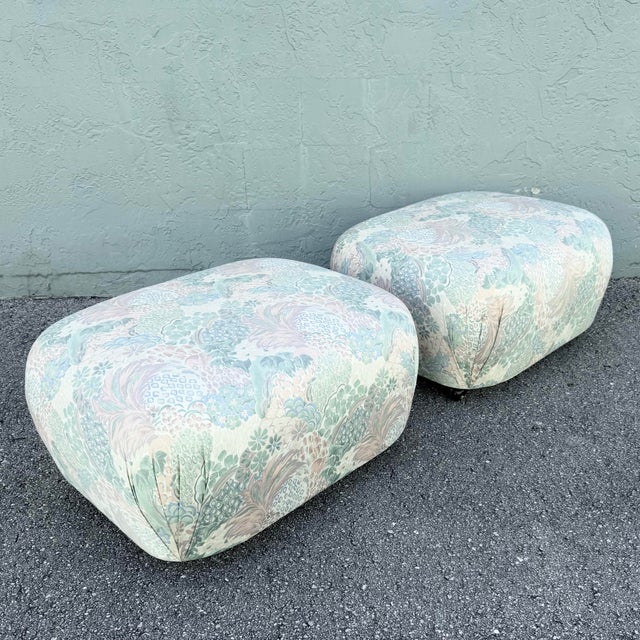 Wrapped in a whimsical pastel floral upholstery, this pair of vintage postmodern ottomans brings playful character and...
