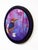 This artwork features an Oriental Pygmy Kingfisher perched on a delicate branch adorned with blossoms, set against a...