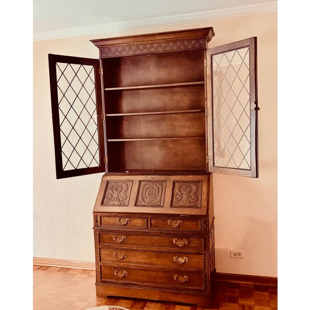 Offered is a vintage traditional Ethan Allen Secretary in heavy grained oak with beautiful carved panels on the drop down...