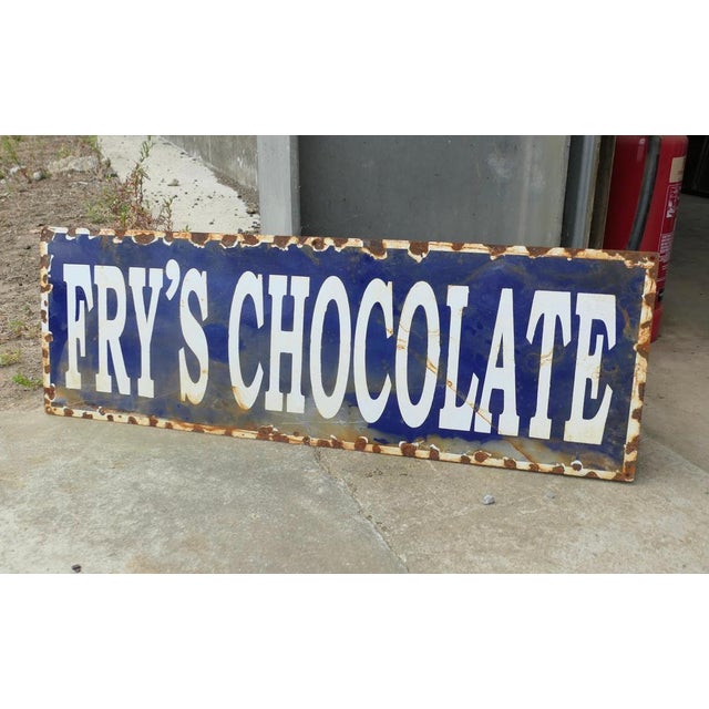 Fry’s Chocolate Enamel Sign This heavy enamel sign is in fair condition for its age, with some chipping around the edge,...