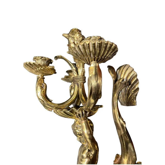 A circa 1900’s Caldwell sconce with cherub on a dolphin holding 3 lights and one light on top shell