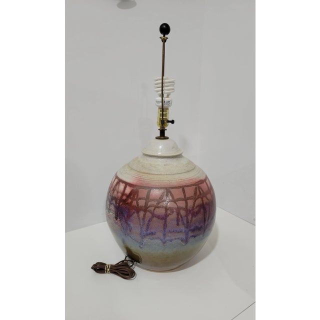 Large Modernist Pottery lamp. Glazed pattern in reds and blues, over a matte beige background. Resembles California...