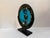 This fused glass platter is a statement piece in any space, with stunning inlays and vibrant blue center. The platter rest...