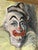An expressive oil painting on canvas depicting the face of a clown with melancholy features, characterized by bold...