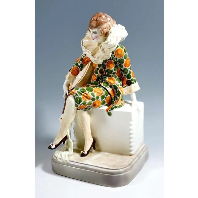 Rare art deco goldscheider ceramics figurine a young musician is depicted who, dressed as pierrette, sits on a pedestal...