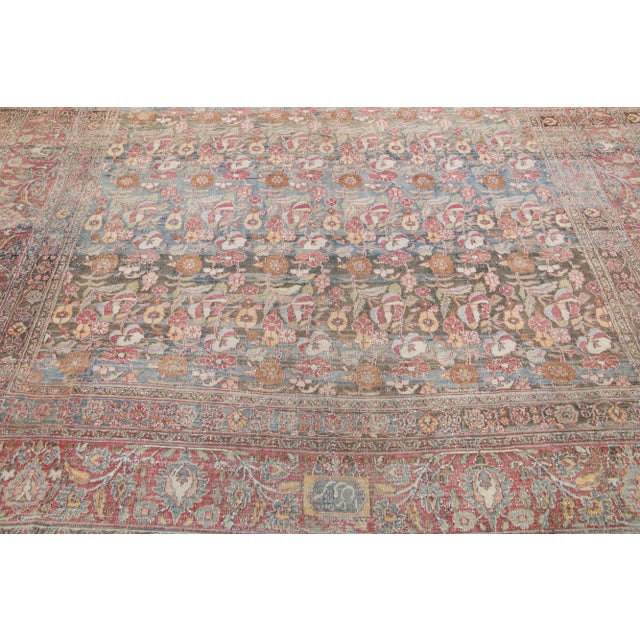 Beautiful hand-knotted antique oversize mahal wool rug with a blue field. This Persian rug has red, brown, and blue accent...