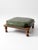 A mid-century Colonial Revival footstool with a square wood base and turned bun feet, topped with a tailored green faux...