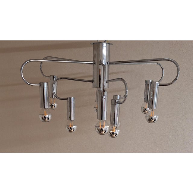 9-Light Flat Chandelier with Curved Chrome-Plated Metal Frame, 1970s, in Very Good conditions. Designed 1970 to 1979...