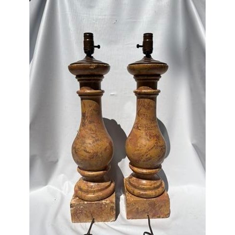 A matching pair of vintage baluster form marble table lamps featuring earth tones including orange, caramel, brown, tan,...