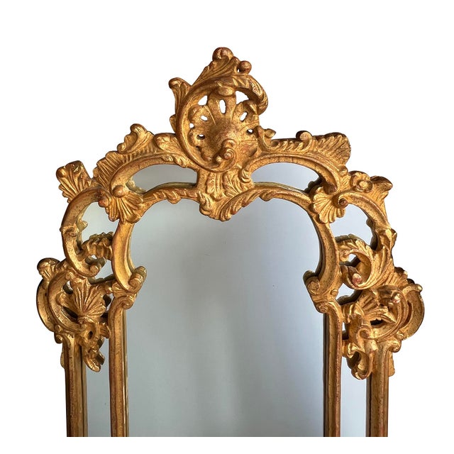 the large hand-carved mirror featuring asymmetrical curves and organic motifs with an openwork rocaille crest above a...