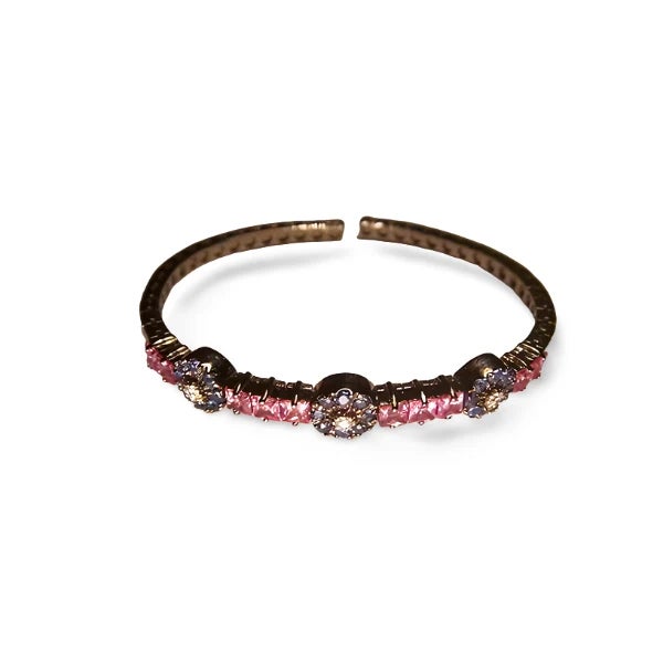 Add a touch of luxury with this 18K white gold bangle, featuring 10 princess-cut pink sapphires 3 carats, 24 round blue...