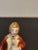 This little gentleman is believed to be a British Colonial. He wears a red coat and is in traditional dress for the time....