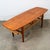 A handsome and well made Danish modern coffee table with cane wrapped shelf beneath. The top surface has been fully...