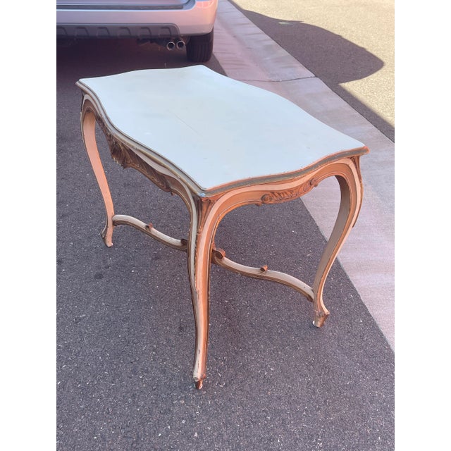 Beautiful French Table purchased in Carmel California . Table boasts a rich creme painted finish with flourishes of...