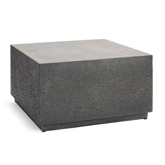 Outdoor concrete coffee table which features a clean monolithic silhouette with a subtly elevated base that gives it...