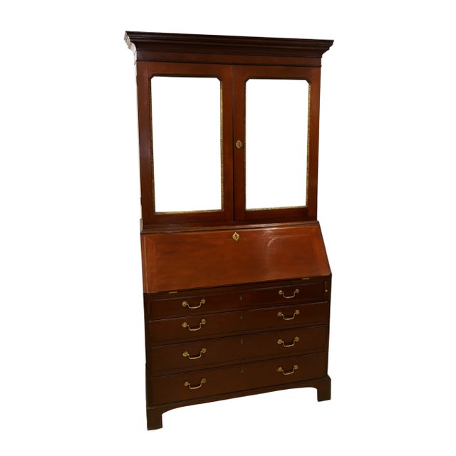 An English George III 18th century mahogany bureau bookcase/ secretary circa 1780. The upper case with a flat cornice over...