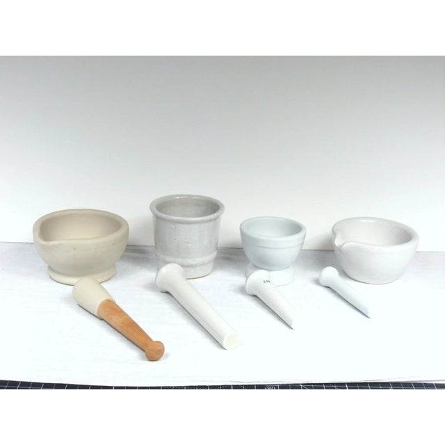 Set of four mortars with pestles for grinding, crushing and pulverizing. Vintage and antique in age. The one on far left...