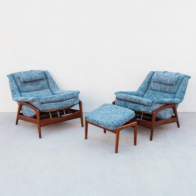 A rare pair of sculptural upholstered recliners with matching ottoman, designed by Folke Ohlsson and produced by DUX of...