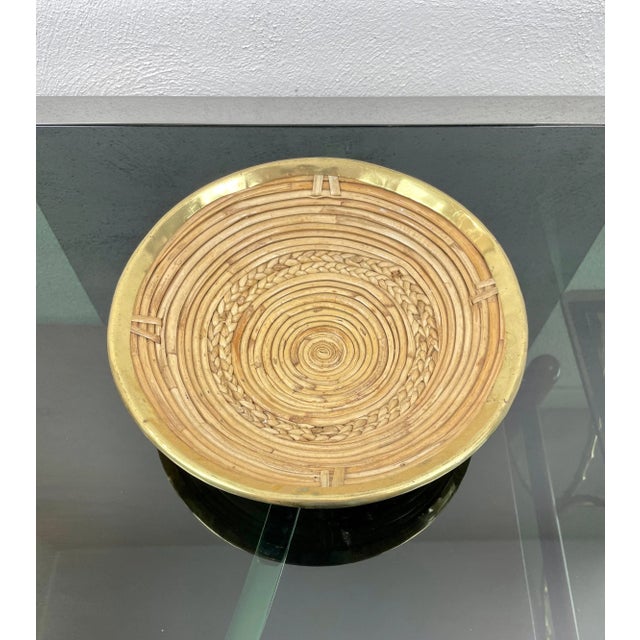 Round centerpiece in rattan framed by brass border made in Italy in the 1970s.