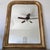 Louis Philippe French mirror with curved top edge. Framing finished in gold guilt with red undertones. Beveled edge glass.