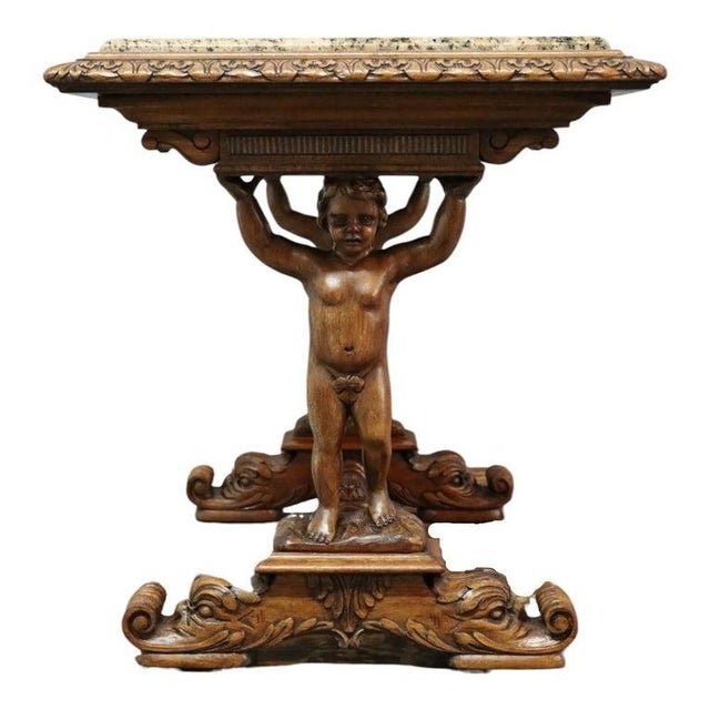 An antique Baroque style table, crafted from carved walnut with a polished granite marble top. This table features highly...