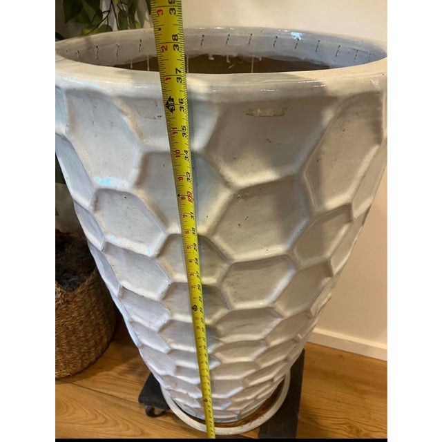 Overscale and highly sculptural, this tall ceramic planter features a bold honeycomb relief pattern that creates depth,...