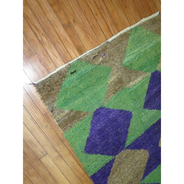 One of a kind Turkish Konya rug in green and purple. Measures: 3'9” x 5'.