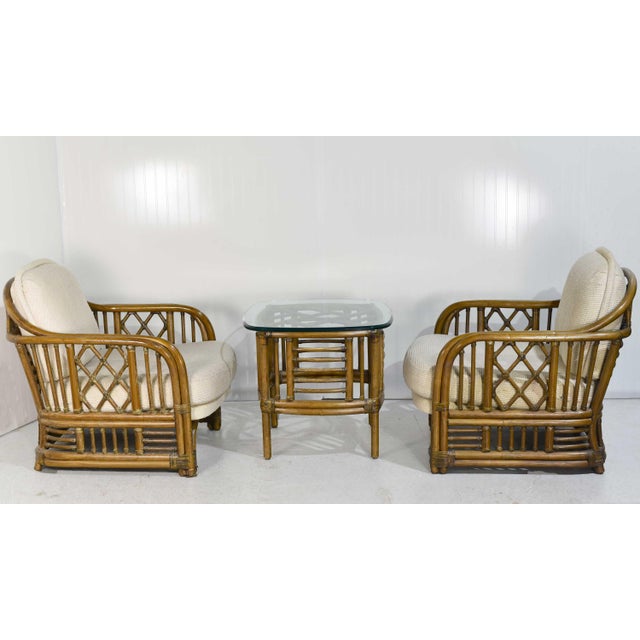 Update your space with this stylish 1970s Rattan Bamboo Lounge Chairs and Table set by Ficks Reed. The natural rattan...
