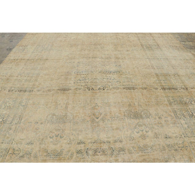 Handwoven in wool, this antique 11x16 Persian Kermanshah rug dates to circa 1890–1900. The softly distressed rug features...
