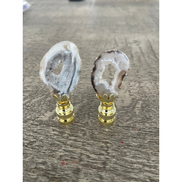 Organic modern nature’s beauty agate geode slices mounted on pronged brass bases as lamp finials.