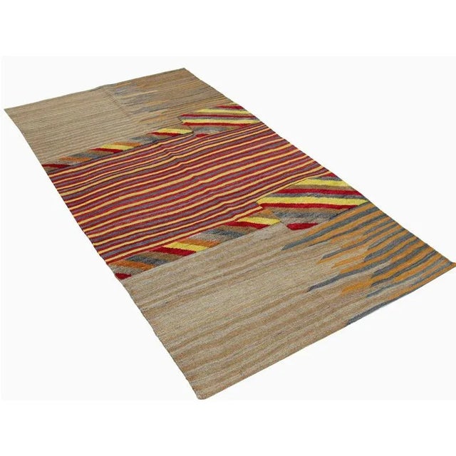 This bewitchingly beautiful example of a Kilim tribal area rug features a contemporary pop of electrifying bright colors...