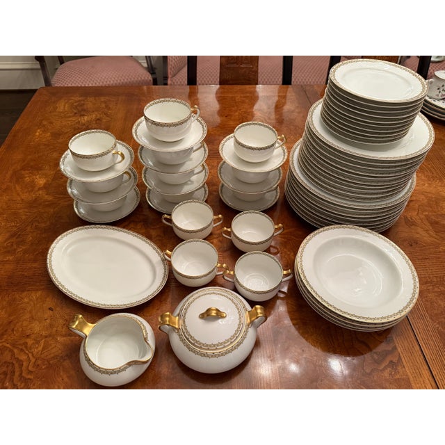 A refined vintage porcelain dinner service by Haviland & Co., Limoges France, in the classic “Albany” pattern featuring a...