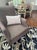 Handsome High-back accent chair by Arhaus, upholstered in a versatile warm taupe-brown textured fabric. The chair features...