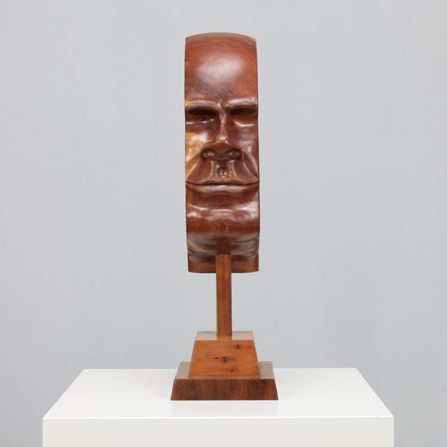 A captivating sculptural portrait by lawrence schneider, hand-carved from rich cherry wood. The work, titled “profile ii”,...