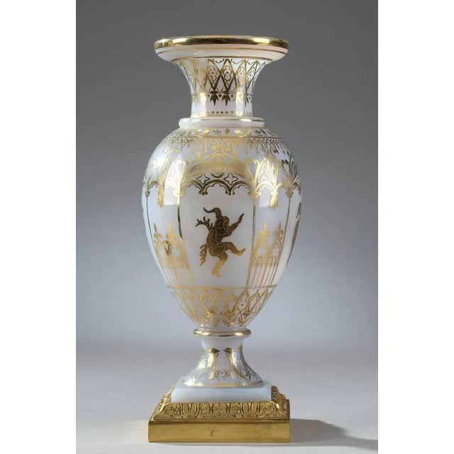 Pair of white opaline glass vases decorated with gilded gothic arcades and medieval figures playing music or dancing. Each...