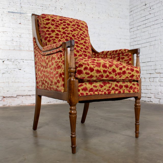 Magnificent vintage French Louis XVI Directoire style bergère chair composed of a petite walnut frame and upholstered in a...