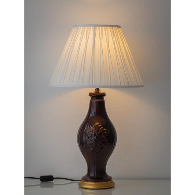 A sculptural mid-century ceramic table lamp from Manises, Valencia, finished in a rich chocolate-brown glaze and newly...