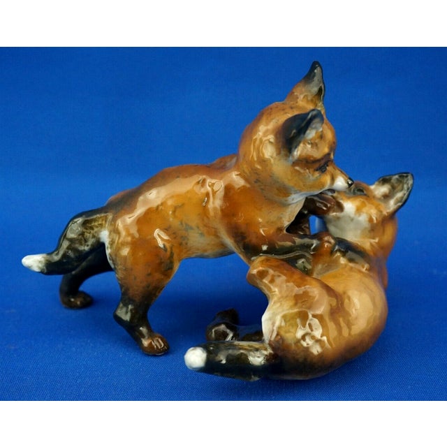 Item : A stunning polychrome hard-paste porcelain sculpture, glazed and entirely hand-decorated, depicting two fox cubs...