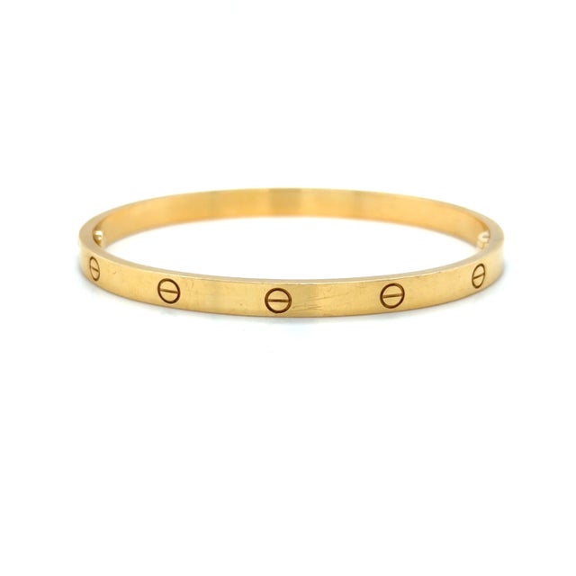 This classic bracelet by Cartier is in the Medium model from their iconic LOVE Collection. Mounted in 18 karat yellow gold...
