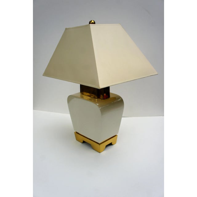 Glam Hollywood Regency Chapman Pagoda table lamp. Cream and brass base and trapezoid shaped original shade with gold...