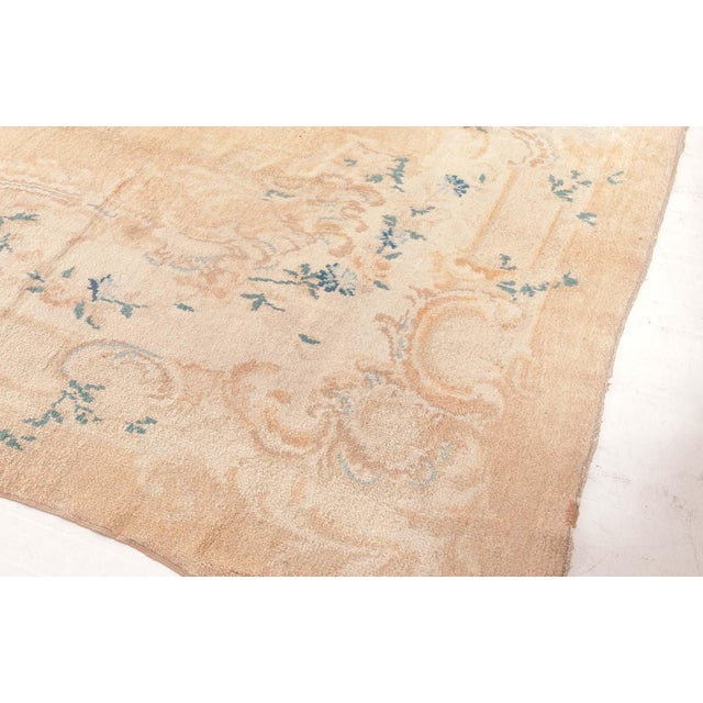 This antique Turkish Angora Oushak rug from the 1920s is a masterclass in quiet elegance and textural luxury. Woven from...