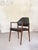 Original Wilkhahn armchair from the 1960s, featuring a rosewood frame and black faux leather upholstery. Based on its...