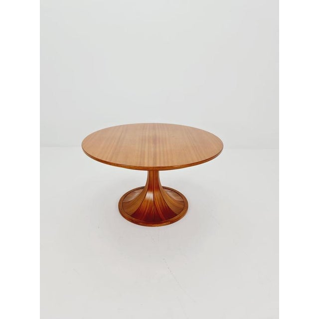 ​Elevate your home with this exquisite walnut table, masterfully designed by the iconic Italian designer Luigi Massoni....