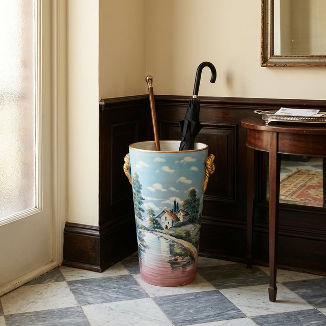 A charming vintage hand-painted ceramic umbrella stand or floor vase in an elegant oval form, decorated with romantic...