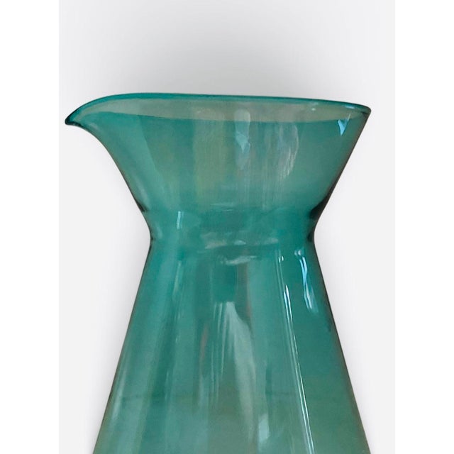 A striking turquoise mold blown modern water carafe. Dimensions are 8’ tall by 5.5’ wide at the base. Mint condition....