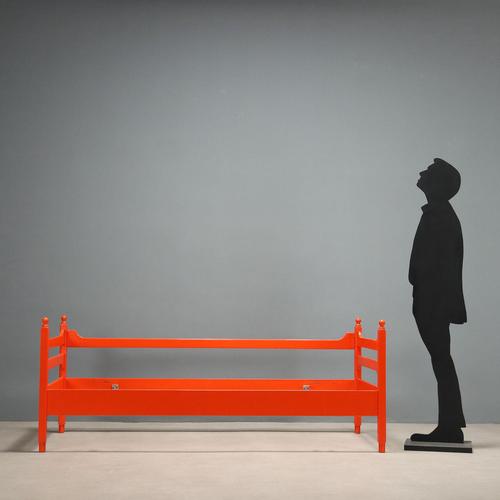 Vintage single bed frame in orange lacquered wood. This piece is attributed to the mentioned designer/maker. It has no...