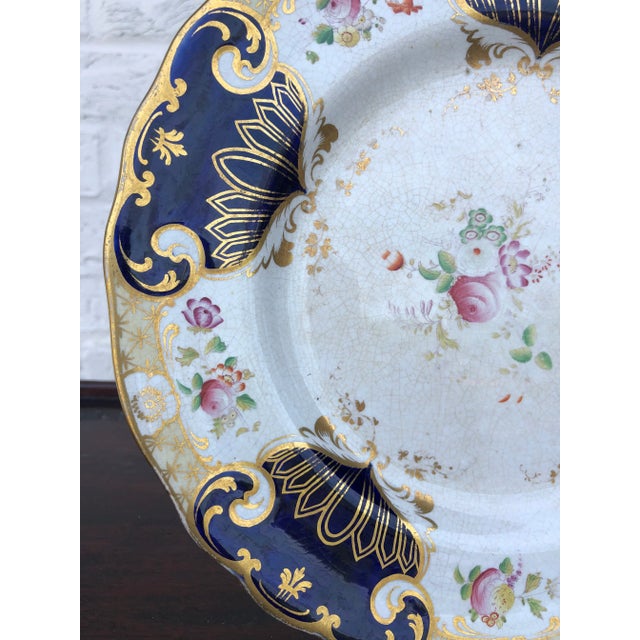 Genuine antique Ironstone China luncheon plate constructed in England in the mid-1800's. Five deep blue motifs are spread...