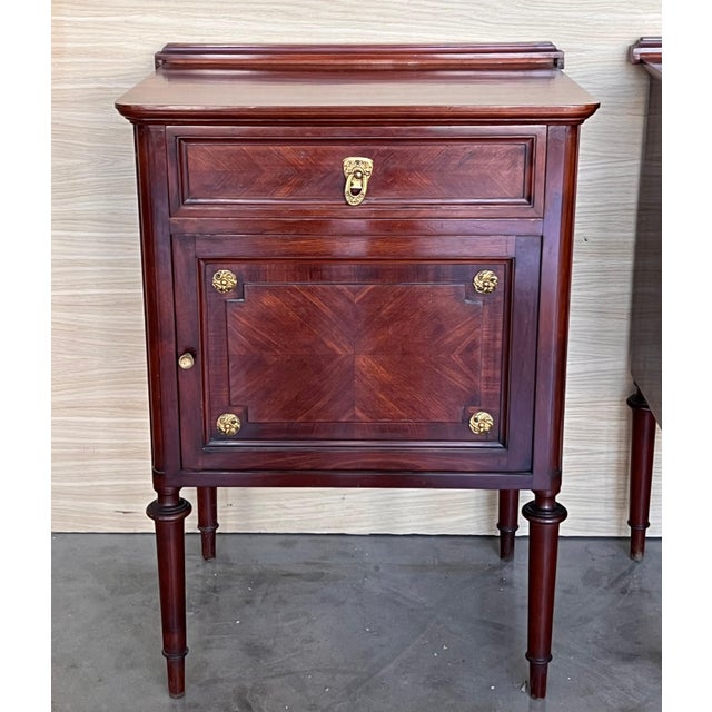 A 19th century French Louis XVI style mahogany side tables, or nightstands, with a fine crest that you can remove. One...