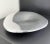 Cast aluminum centerpiece bowl with sinuous, organic form and polished mirrored metal finish. Designed by sculptor and...